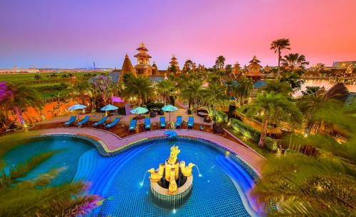 an overhead view of a resort pool at night at Ammata Lanta Resort in Lat Krabang