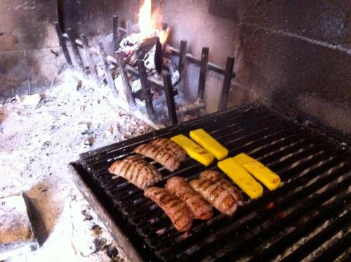 a bunch of food is cooking on a grill at Agriturismo Casa Rosa in Verona
