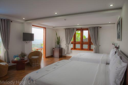 Postel nebo postele na pokoji v ubytování Melody Hotel