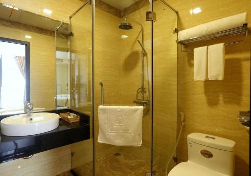 a bathroom with a toilet and a sink and a shower at Soo Hotel Bac Ninh in Bắc Ninh