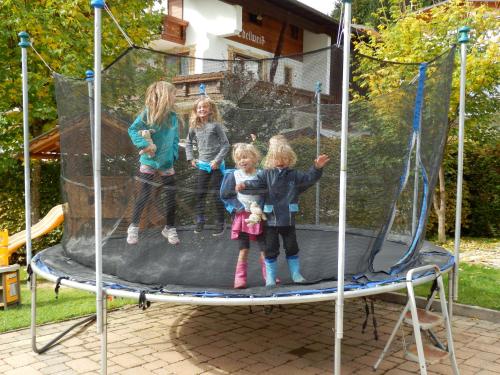 four girls are standing on a trampoline at Haus Seebach in Berwang
