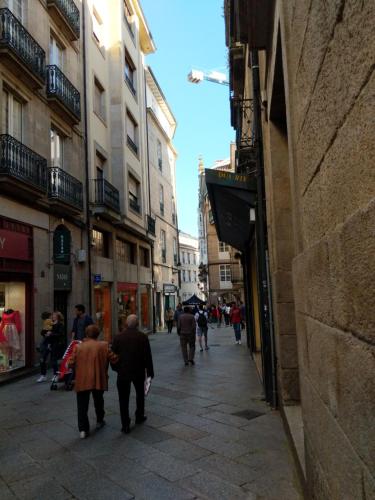 a group of people walking down a street at Burgas Termal in Ourense