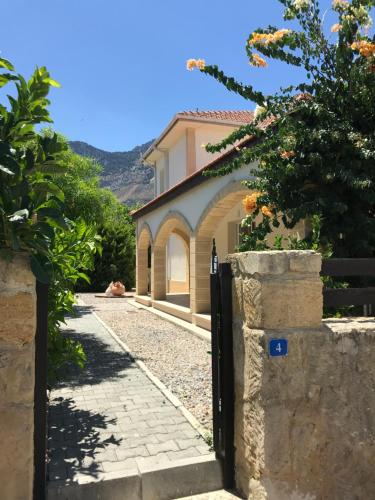 a gate to a house with a dog laying on the ground at Casa Santos Kyrenia in Kérynia