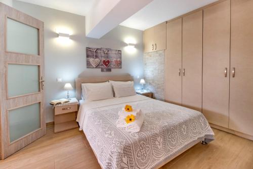 a bedroom with a white bed with flowers on it at Sweet home apartment in Gaios