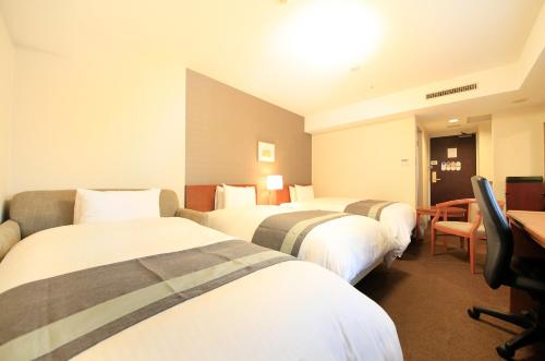 Cama ou camas em um quarto em Richmond Hotel Sapporo Odori