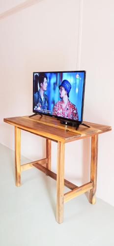 a laptop computer sitting on top of a wooden table at Banyan Resort Bangsaen in Bangsaen