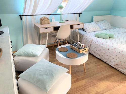 a room with two beds and a desk and a table at Dom z Sauną i Jacuzzi- na wyłączność lub pokoje in Serock