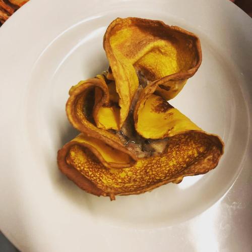 a white plate with a piece of bread with mustard at Hotel Flora in Cesenatico