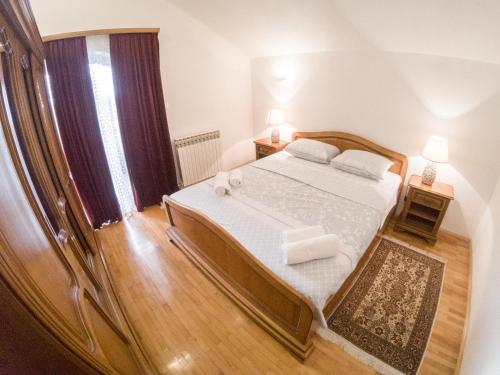 a bedroom with a bed with two towels on it at Villa Katarina with pool in Banja Luka