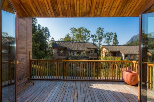 an open deck with a view of a house at Evergreen Retreat-walk to National Forest Park, free pick up service in Zhangjiajie