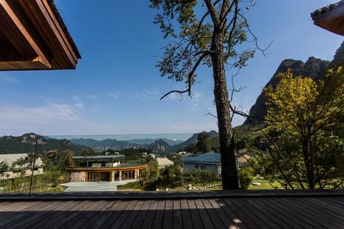 a view from the deck of a house with a tree at Evergreen Retreat-walk to National Forest Park, free pick up service in Zhangjiajie
