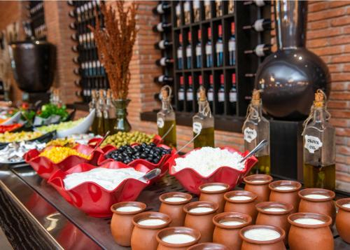 a buffet of food and bottles of wine on a table at Ambassadori Kachreti Golf Resort in Kachretʼi