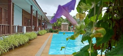a swimming pool in the middle of a building at Khum Laanta Resort - SHA Extra Plus in Ko Lanta