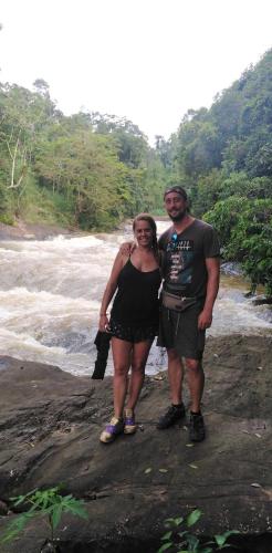 a man and a woman standing next to a river at Rainforest Holiday Inn in Deniyaya