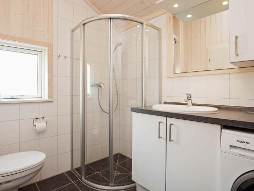 a bathroom with a shower and a toilet and a sink at Holiday home Großenbrode IX in Großenbrode