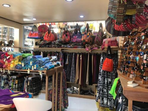 a store filled with lots of bags and purses at Game Bar in Surat Thani