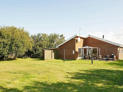 a barn with a grass field in front of it at 6 person holiday home in Asn s in Asnæs