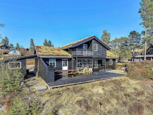 a large house with a roof with a deck at 10 person holiday home in SERAL in Åseral