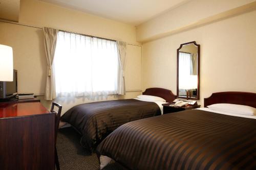 Llit o llits en una habitació de Hotel Sunlife