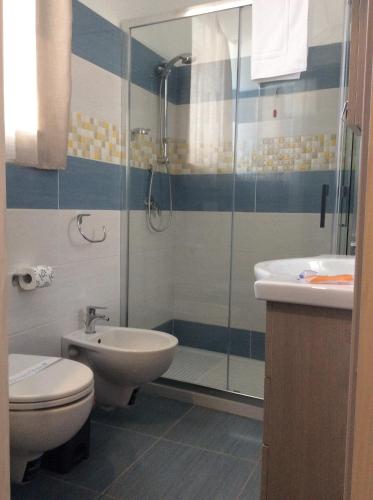a bathroom with a shower and a toilet and a sink at Naxos Laguna Beach in Giardini Naxos