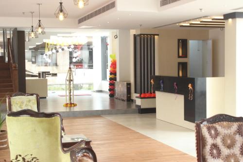 a lobby of a store with chairs and tables at The Hotel Canoe in Kannur