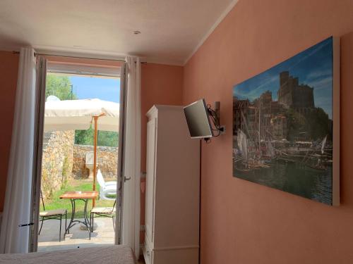 a bedroom with a painting of a castle on the wall at Agriturismo La Pietra 1 e La Pietra 2 in La Spezia