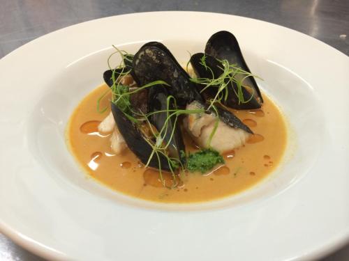 a plate of food with mussels in a sauce at The Commodore Hotel in Instow