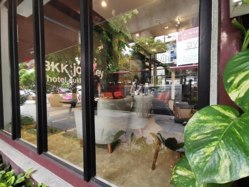 a store window with a table and chairs in it at A Bangkok Journey in Bangkok