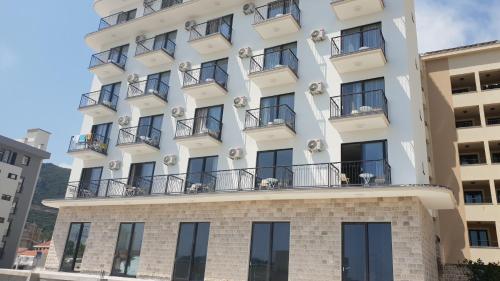 a building with balconies on top of it at Hotel Svarog in Bečići