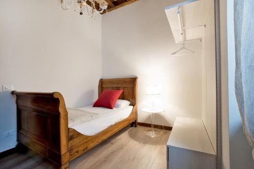 a small bedroom with a bed with a red pillow at Residenza Duomo3 - Apartments in Verona