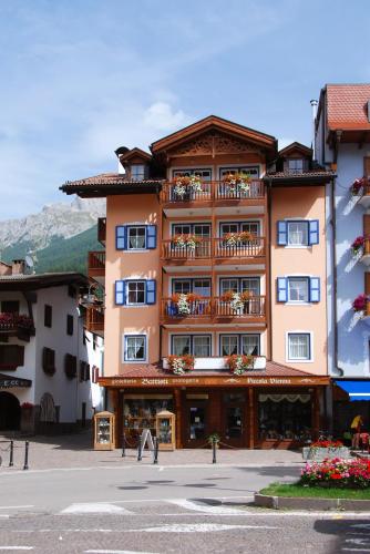 a large building with balconies on the side of it at Attico Faloria Luxury in Moena