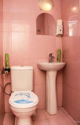 a pink bathroom with a toilet and a sink at Soul Kitchen in Tbilisi City
