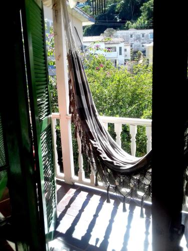 a porch with a hammock on a balcony at Muqui91 in Teresópolis