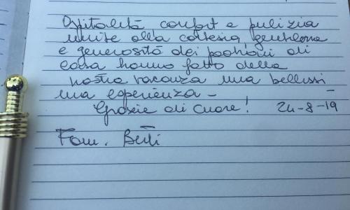 a letter written in cursive handwriting on a lined paper at La Casa del Sole in Marina di Pisticci