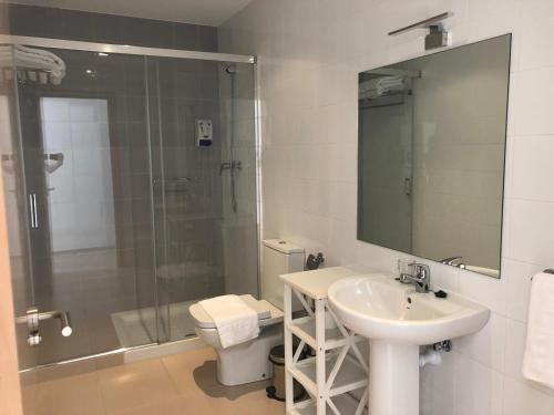 a bathroom with a sink and a shower and a toilet at Camino De Rabe in Rabé de las Calzadas