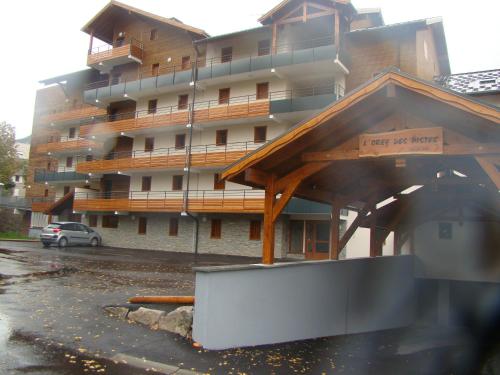 a large apartment building with a parking lot in front of it at Mar Mar Appartaments in Briançon