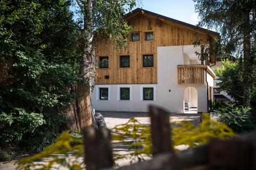 a house with a fence in front of it at Chalet Dolomit in San Lorenzo di Sebato
