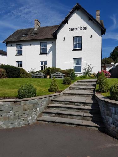 a white house with a stone walkway in front of it at Diamond Lodge Boutique Adults Only Guest House in Ambleside