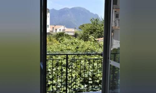 an open window with a view of a mountain at A casa di Pissi - apartment in Ravello