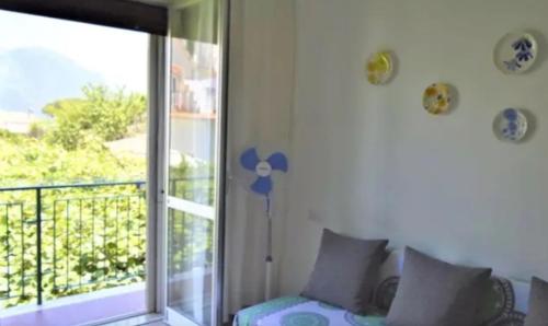 a room with a balcony with a sliding glass door at A casa di Pissi - apartment in Ravello