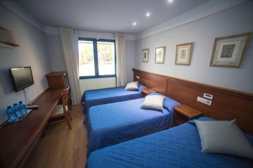 Postel nebo postele na pokoji v ubytování Hotel Alba