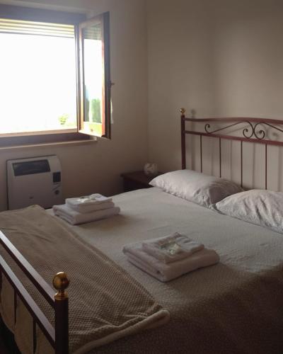 a bedroom with two beds with towels on them at Casa Alice in Camigliatello Silano