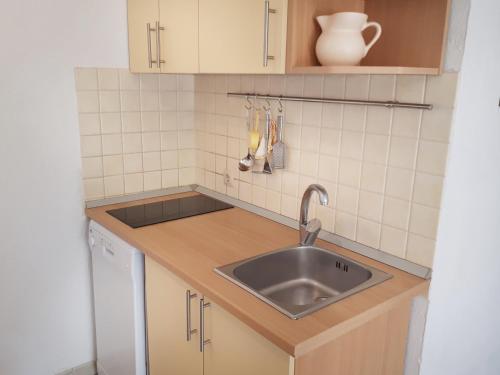 a kitchen with a sink and a counter top at Apartments Zoe in Bol