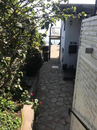 a walkway leading up to a building with plants at Laura del Mar Hotel Boutique in Concón