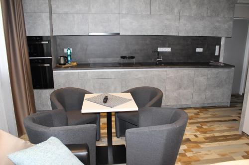 a room with a table and chairs and a kitchen at Quad room in Apartments 461, room No. 9 in Modřice