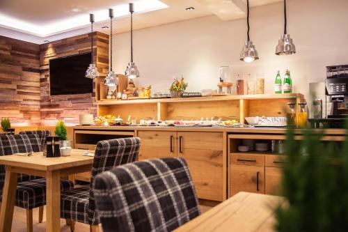 a kitchen with a table and chairs and a tv at Hotel Tannenhaus in Schöneck