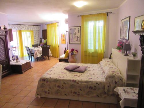 a bedroom with two beds and a living room at Gatto Matto in Manziana