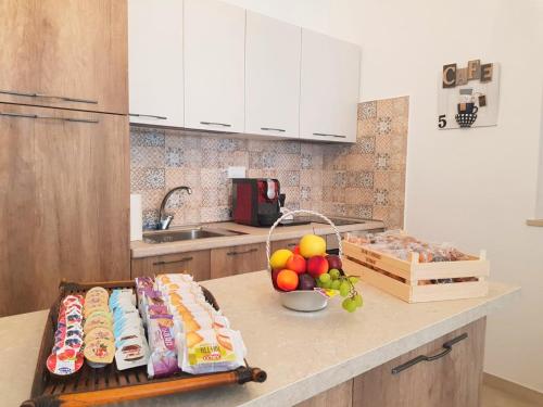 a kitchen with a counter with food and a bowl of fruit at B&B Locanda Criloro in Pescara
