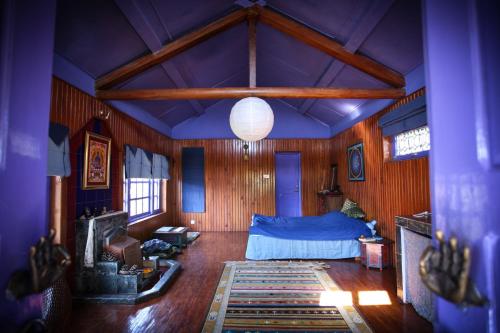 a bedroom with a bed in a room with purple walls at Joy Source Resort in Kathmandu