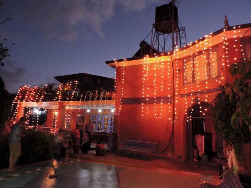 a building with christmas lights on the side of it at Joy Source Resort in Kathmandu